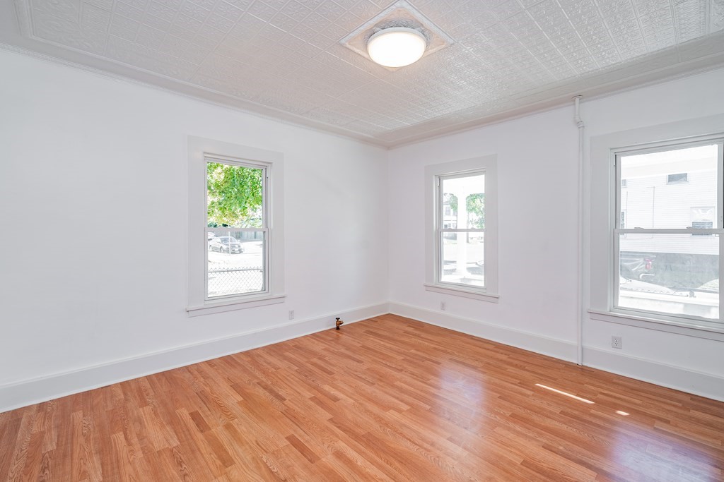 240 Centre Street Springfield, MA 01151 - Photo 11 of 23 an empty room with wooden floor and windows