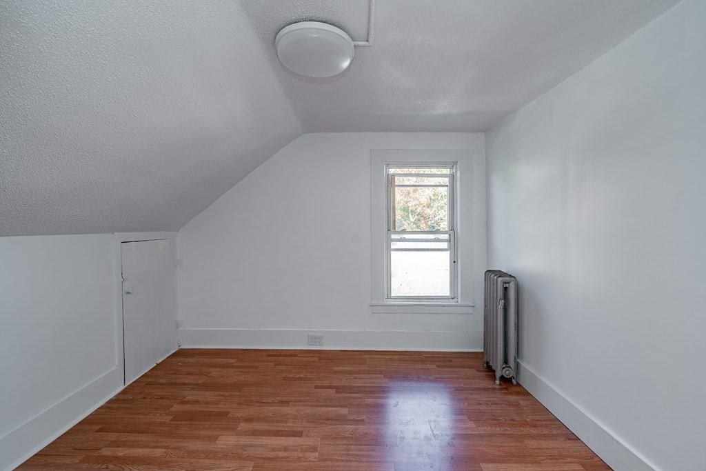 240 Centre Street Springfield, MA 01151 - Photo 15 of 23 a view of an empty room with wooden floor and a window