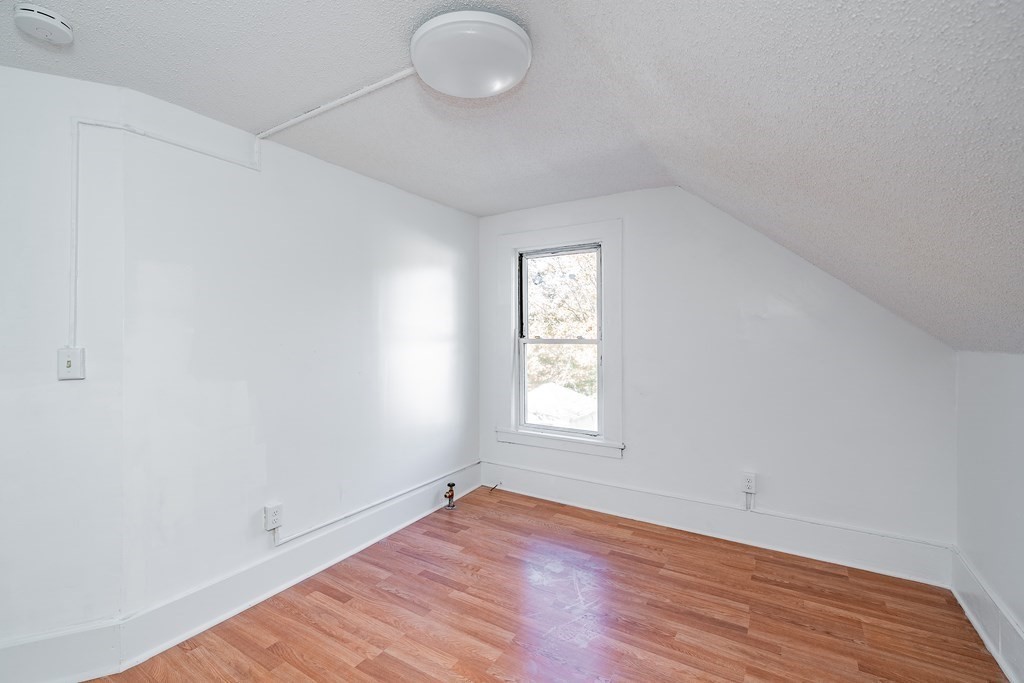 240 Centre Street Springfield, MA 01151 - Photo 17 of 23 an empty room with wooden floor and windows