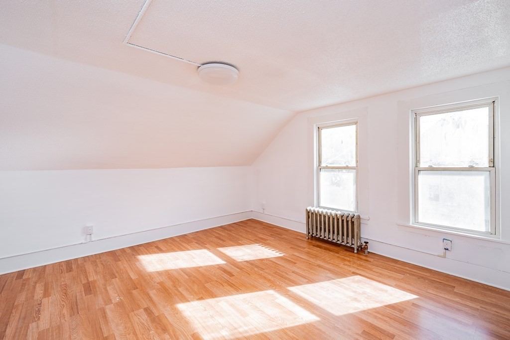240 Centre Street Springfield, MA 01151 - Photo 18 of 23 an empty room with wooden floor and windows