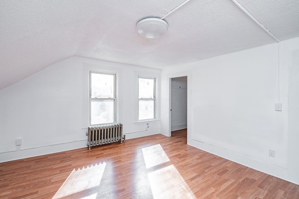 240 Centre Street Springfield, MA 01151 - Photo 19 of 23 an empty room with wooden floor and windows