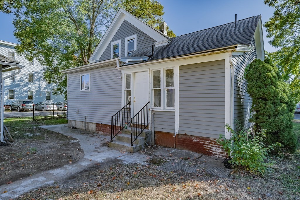 240 Centre Street Springfield, MA 01151 - Photo 23 of 23 a view of a house with a yard and lawn chairs under an umbrella