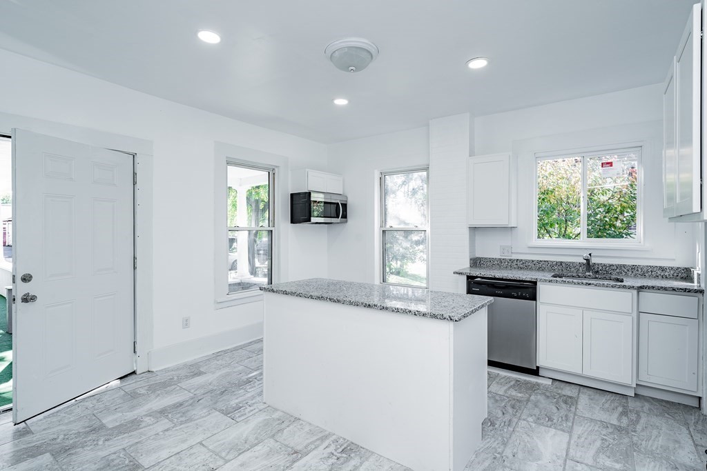 240 Centre Street Springfield, MA 01151 - Photo 3 of 23 a kitchen with granite countertop a sink and white cabinets