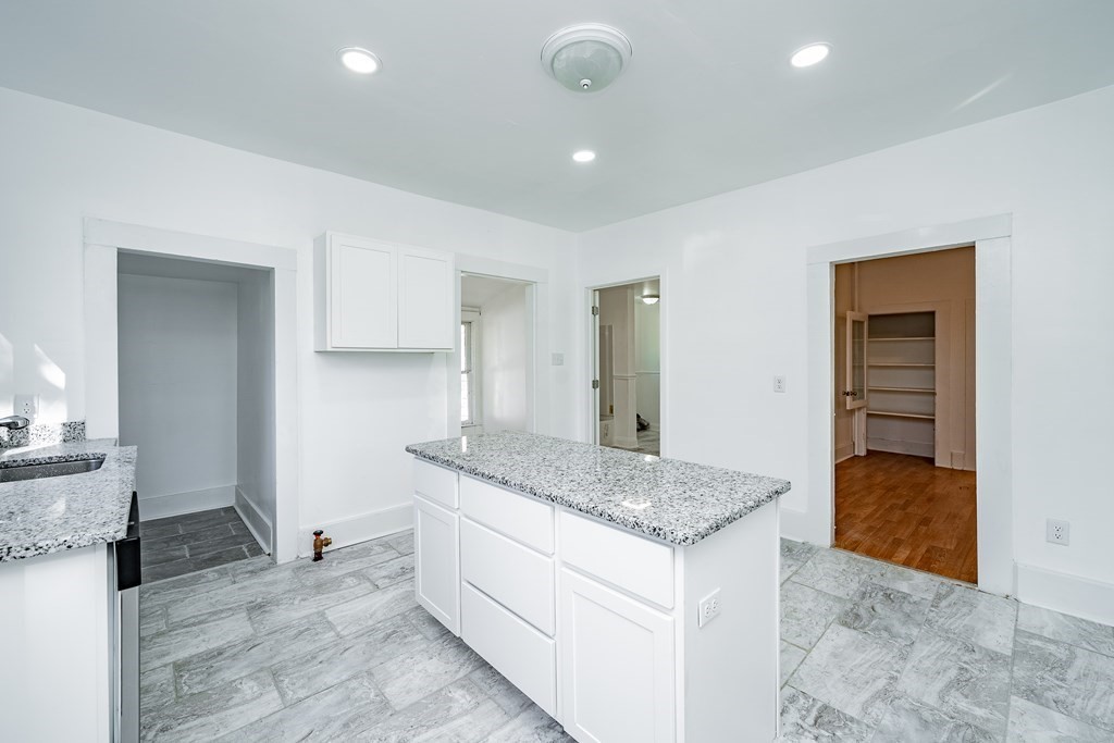 240 Centre Street Springfield, MA 01151 - Photo 5 of 23 a kitchen with a sink granite counter tops and a stove