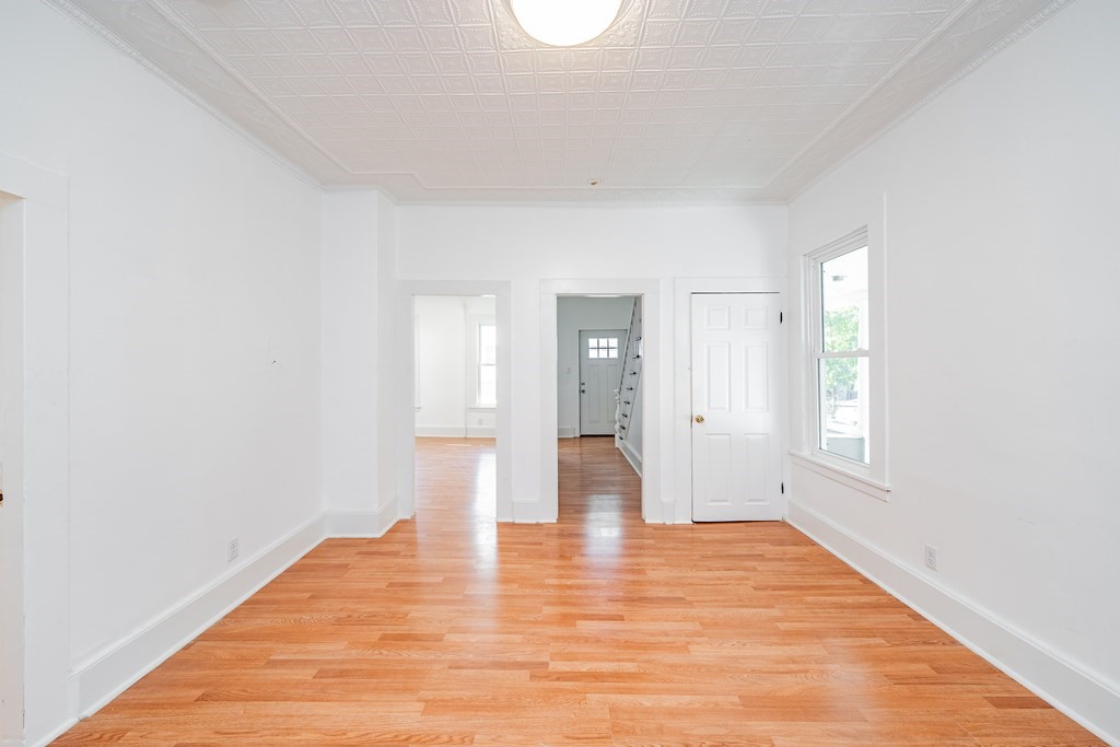 240 Centre Street Springfield, MA 01151 - Photo 8 of 23 a view of empty room with wooden floor and fan