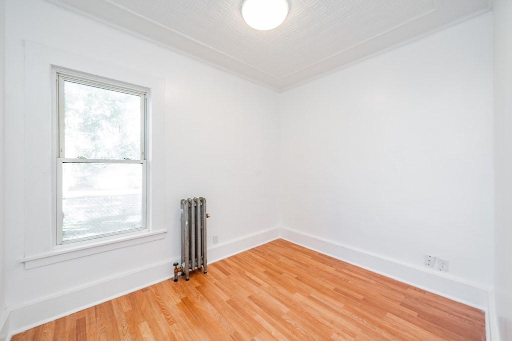 240 Centre Street Springfield, MA 01151 - Photo 10 of 23 a view of empty room with wooden floor and fan