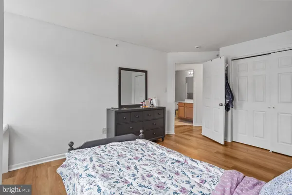 a bedroom with a bed and a dresser in it