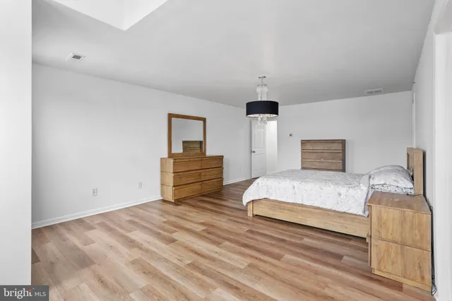 a spacious bedroom with a bed and window