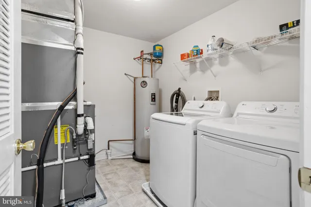 a view of storage and utility room with washer and dryer