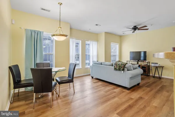 a living room with furniture wooden floor and a chandelier