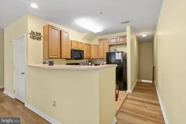 a view of kitchen with cabinets and wooden floor