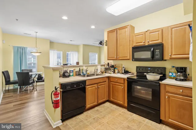 a kitchen with stainless steel appliances granite countertop a stove and a sink