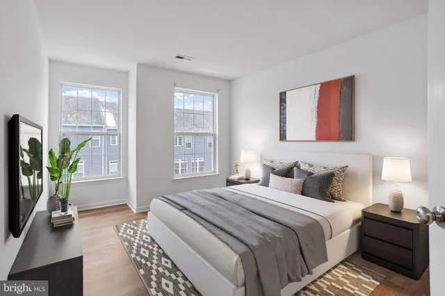 a bedroom with a bed table and a window