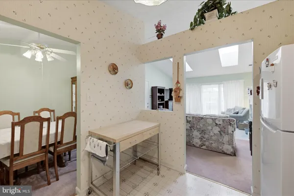 a kitchen that has a lot of cabinets in it and stainless steel appliances