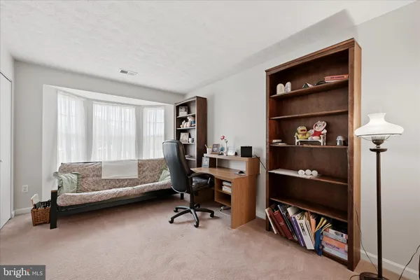 a bedroom with a bed and a bookshelf