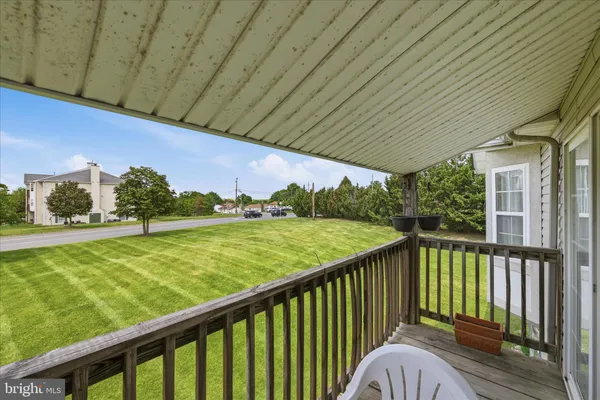 a view of a deck with wooden floor and fence