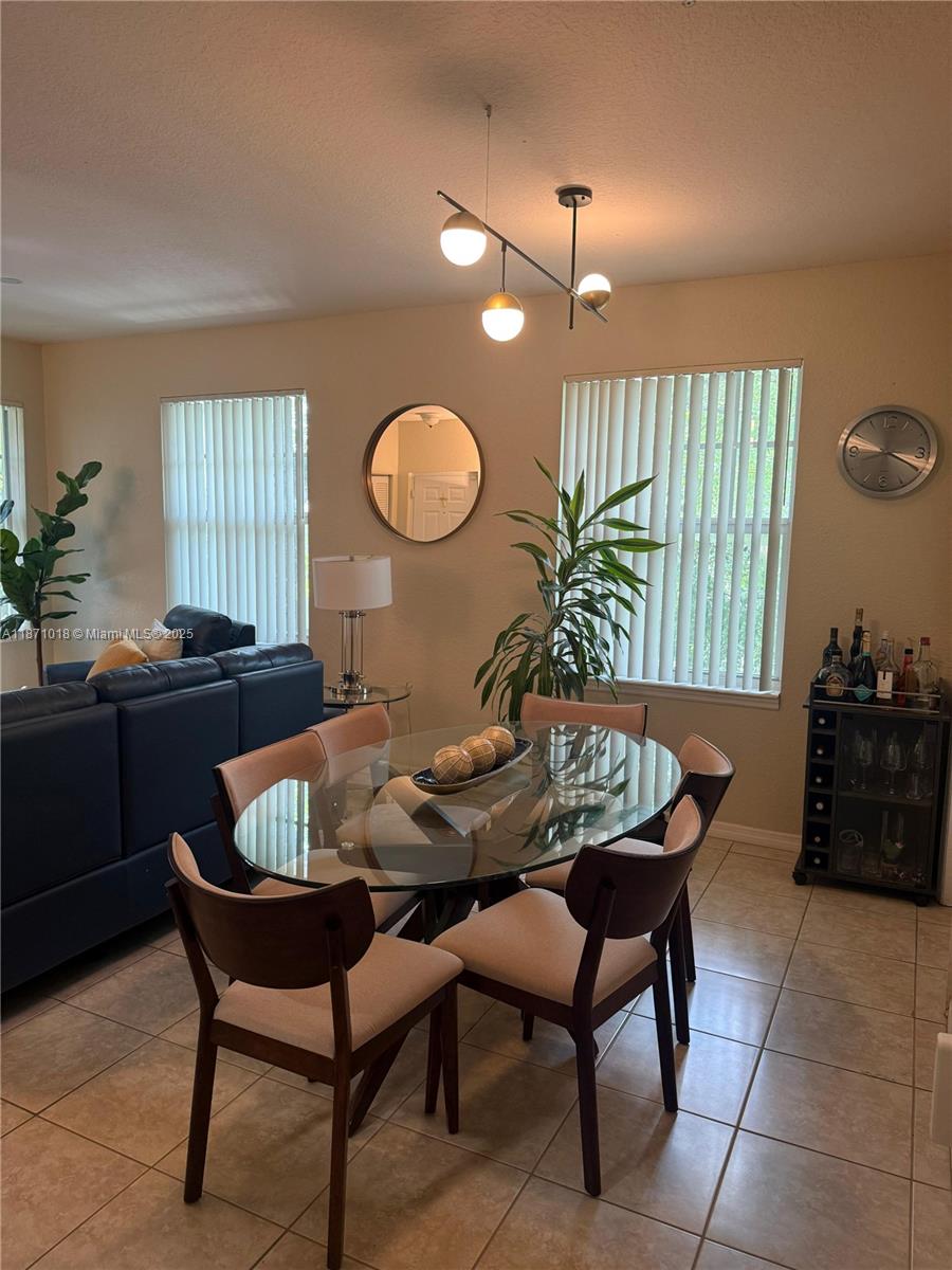 6876 West Sample Road, Unit 6876 Coral Springs, FL 33067 - Photo 16 of 27 a view of a dining room with furniture