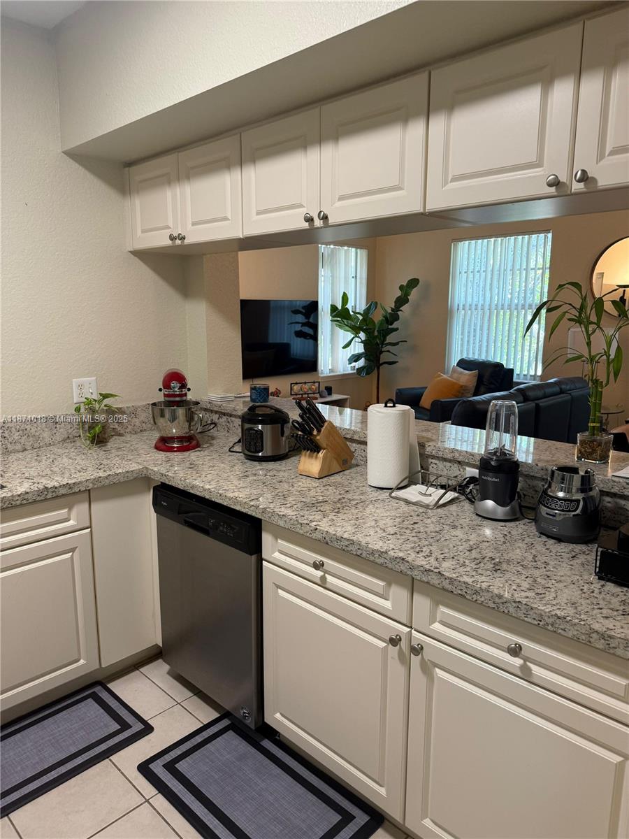 6876 West Sample Road, Unit 6876 Coral Springs, FL 33067 - Photo 19 of 27 a kitchen with a sink appliances and cabinets