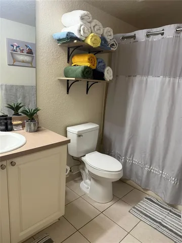 a bedroom with a bed and painting on the wall