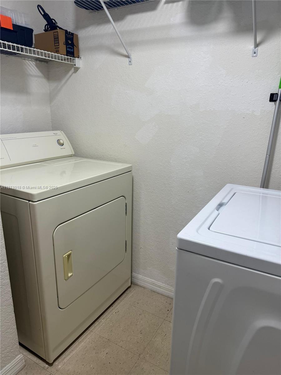 6876 West Sample Road, Unit 6876 Coral Springs, FL 33067 - Photo 25 of 27 a utility room with dryer and washer