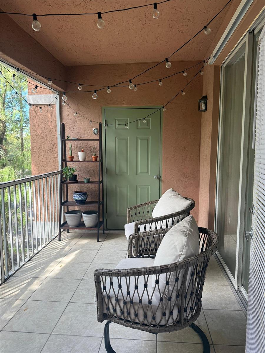 6876 West Sample Road, Unit 6876 Coral Springs, FL 33067 - Photo 26 of 27 a balcony with furniture and a potted plant