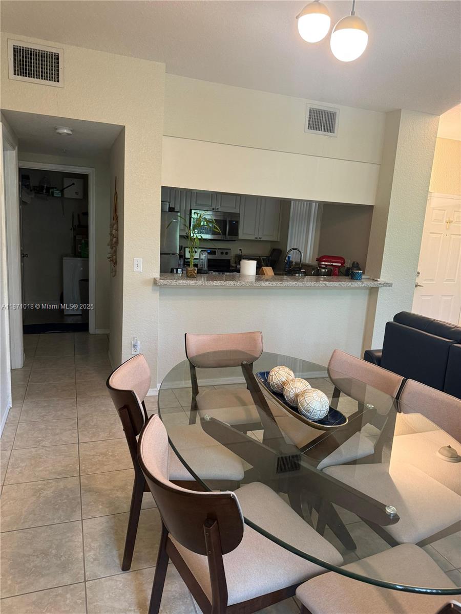 6876 West Sample Road, Unit 6876 Coral Springs, FL 33067 - Photo 27 of 27 a living room with furniture and a flat screen tv