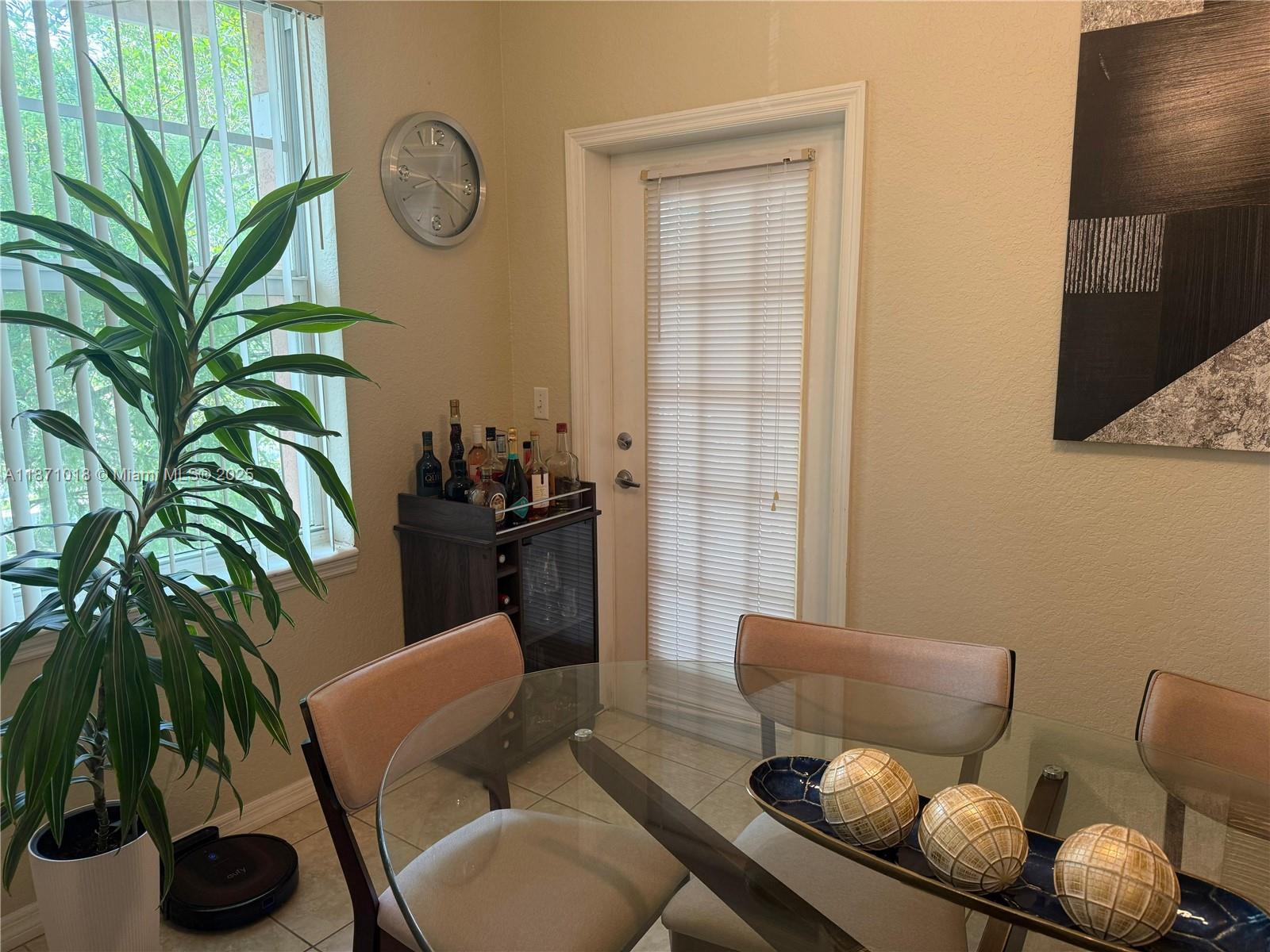 6876 West Sample Road, Unit 6876 Coral Springs, FL 33067 - Photo 3 of 27 a bathroom with a toilet a sink and a mirror