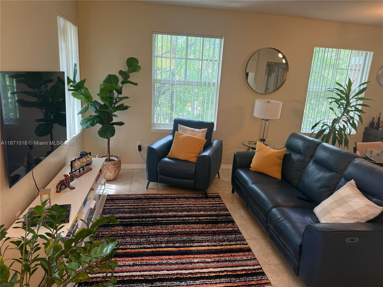 6876 West Sample Road, Unit 6876 Coral Springs, FL 33067 - Photo 7 of 27 a living room with furniture and a potted plant
