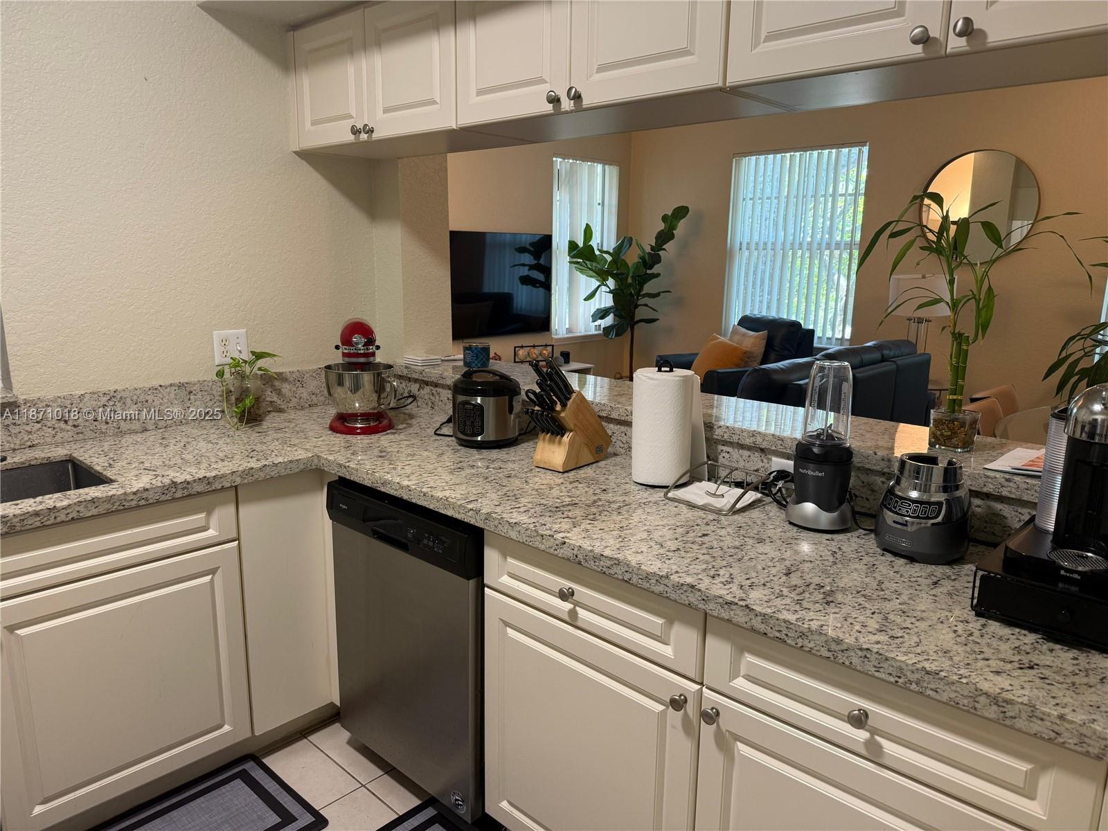 6876 West Sample Road, Unit 6876 Coral Springs, FL 33067 - Photo 8 of 27 a kitchen with sink and a refrigerator