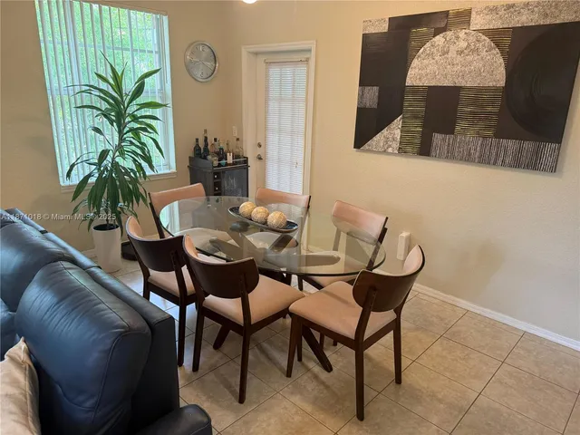a dining room with furniture and rug