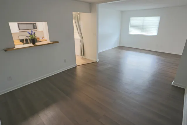 a view of a room with wooden floor and cabinet