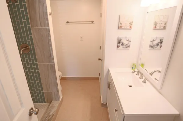 a bathroom with a bathtub sink and mirror