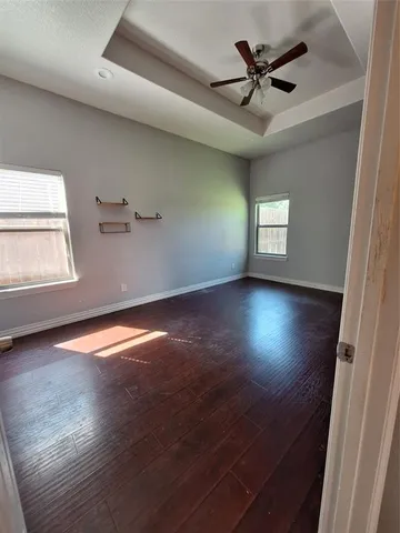 wooden floor in an empty room with a window
