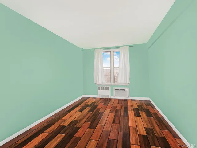 a view of a room with wooden floor and window