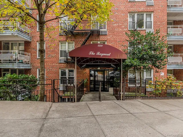 a front view of a building with a garden