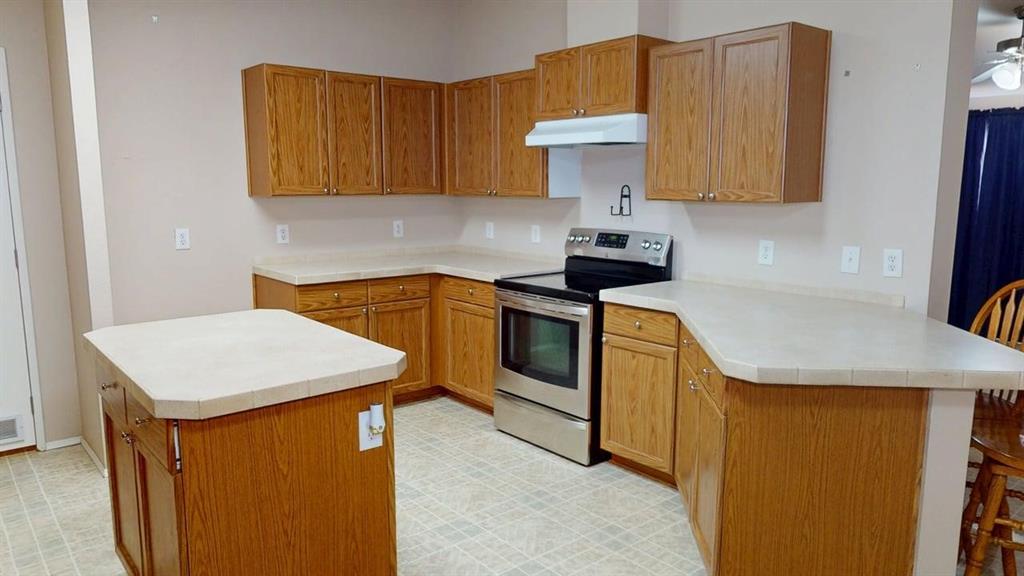 1301 East Pontotoc Street Mason, TX 76856 - Photo 13 of 26 a kitchen with stainless steel appliances a stove a microwave a sink and cabinets