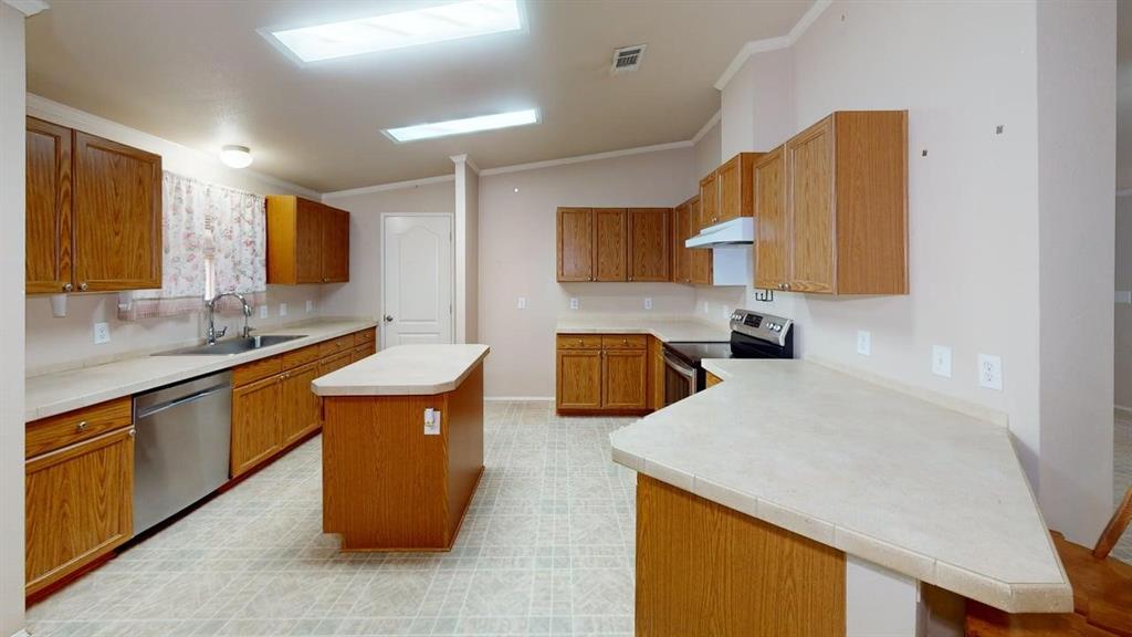 1301 East Pontotoc Street Mason, TX 76856 - Photo 14 of 26 a kitchen with stainless steel appliances granite countertop a sink and a refrigerator