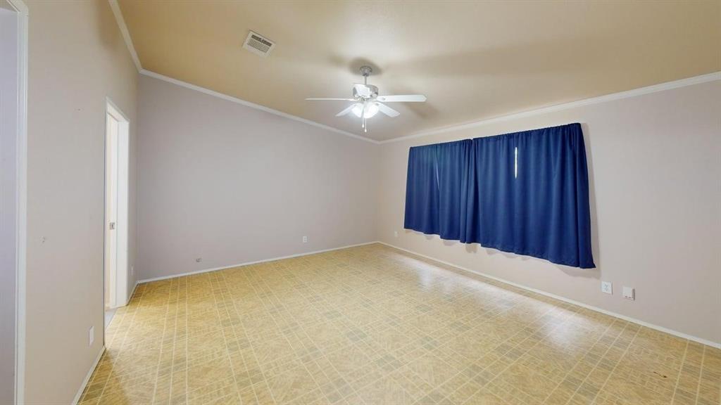 1301 East Pontotoc Street Mason, TX 76856 - Photo 17 of 26 an empty room with a ceiling fan and a window
