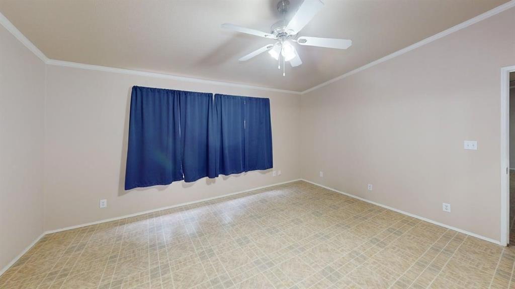 1301 East Pontotoc Street Mason, TX 76856 - Photo 18 of 26 an empty room with a chandelier fan