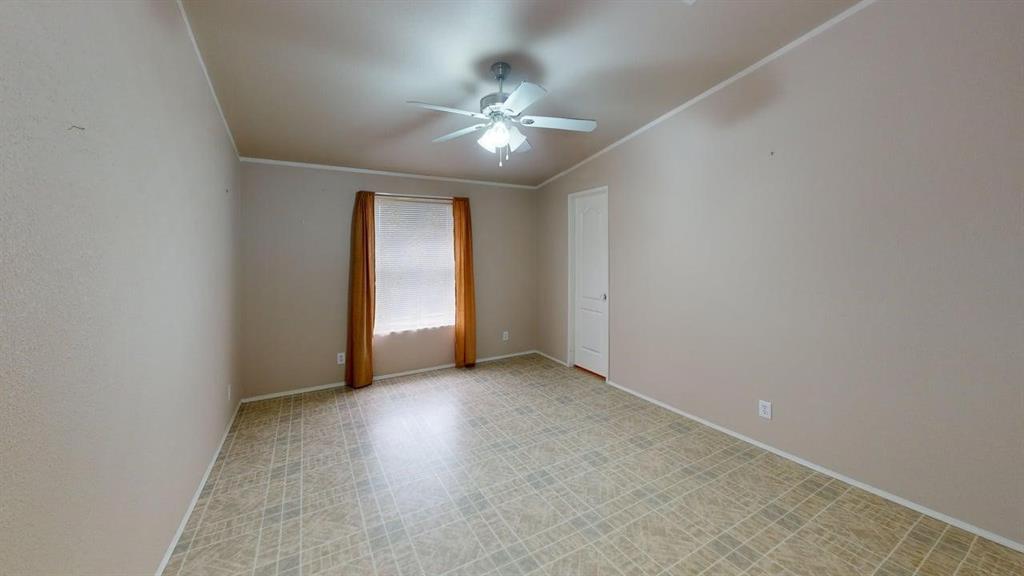 1301 East Pontotoc Street Mason, TX 76856 - Photo 22 of 26 an empty room with fan and windows