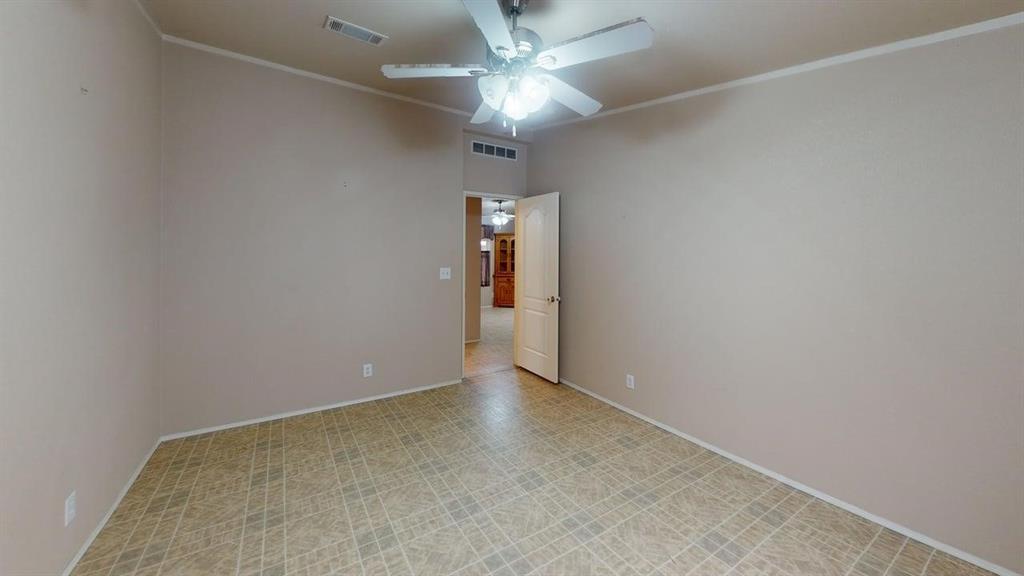 1301 East Pontotoc Street Mason, TX 76856 - Photo 23 of 26 an empty room with a chandelier fan and a ceiling fan