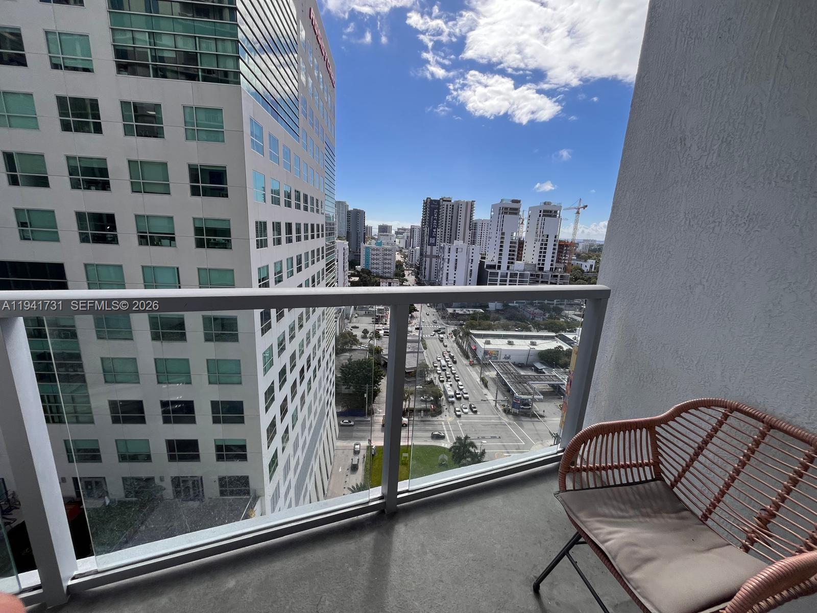 185 Southwest 7th Street, Unit 2006 Miami, FL 33130 - Photo 14 of 14 a view of a balcony with furniture and chandelier