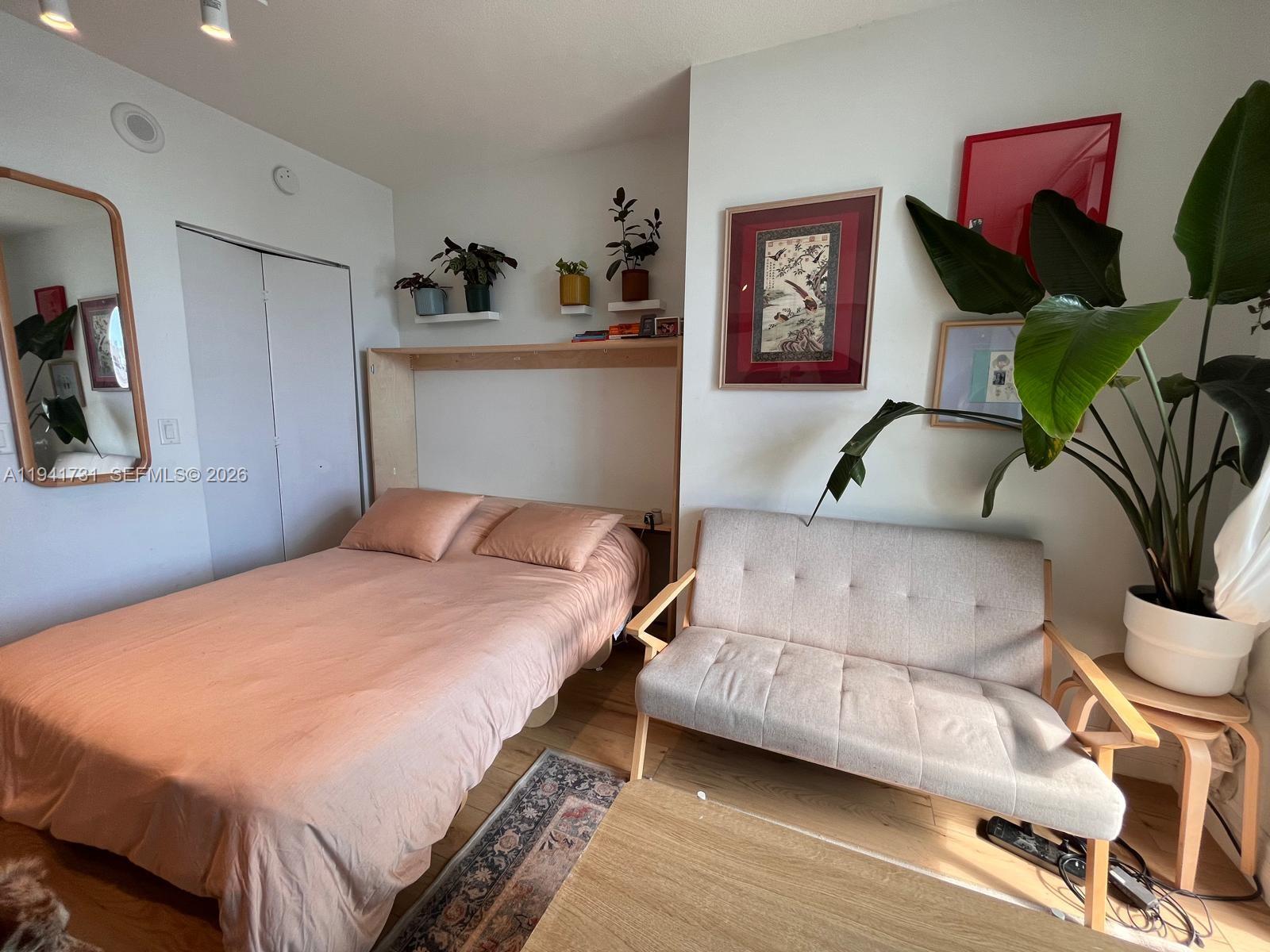 185 Southwest 7th Street, Unit 2006 Miami, FL 33130 - Photo 4 of 14 a bedroom with a bed and cabinets