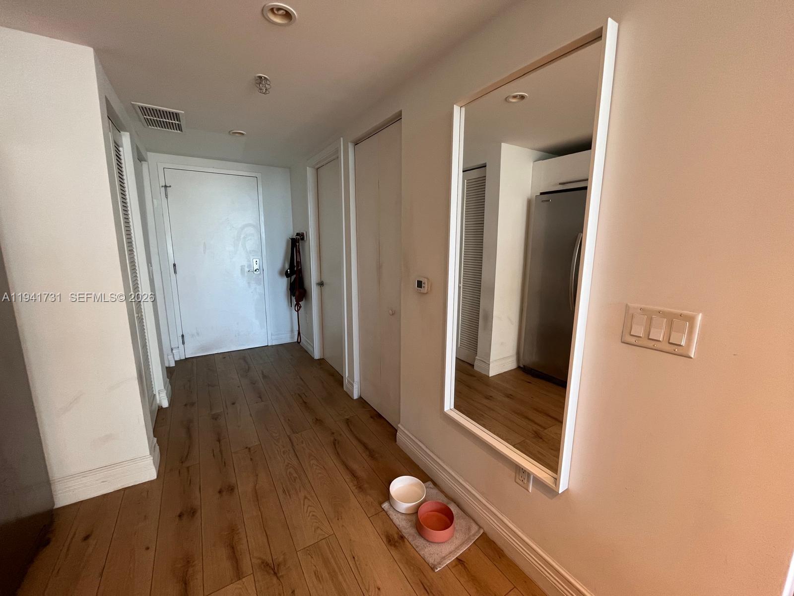 185 Southwest 7th Street, Unit 2006 Miami, FL 33130 - Photo 9 of 14 a view of hallway with wooden floor