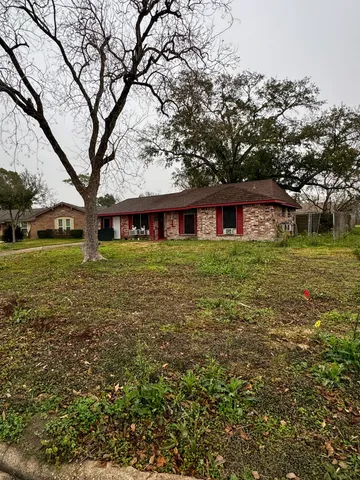 a view of a house with garden and trees