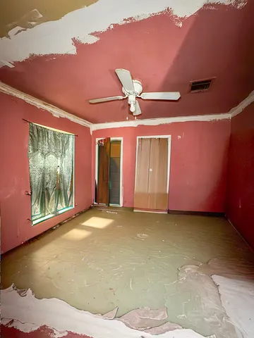 a view of a livingroom with a ceiling fan and window