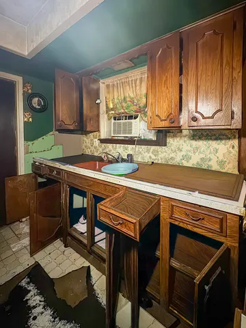 a bathroom with a granite countertop sink a toilet and shower curtain