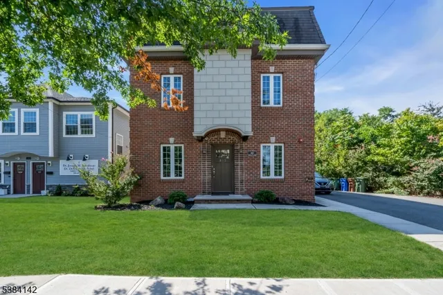 a front view of house with a garden