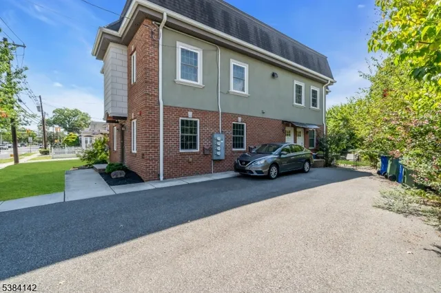 a car parked in front of white house