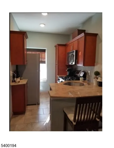 a kitchen with a refrigerator a sink and cabinets